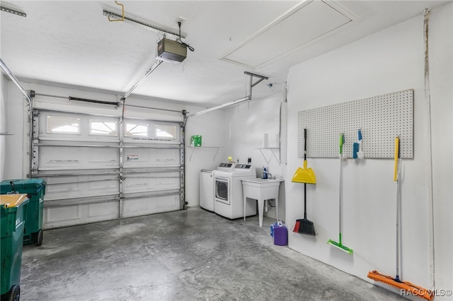 garage with a garage door opener and separate washer and dryer