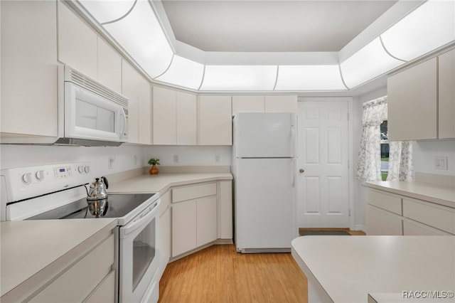 kitchen featuring white cabinetry, white appliances, light countertops, and light wood finished floors