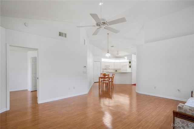 unfurnished living room with visible vents, baseboards, light wood-style floors, high vaulted ceiling, and a ceiling fan