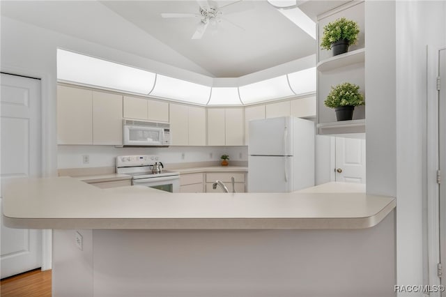 kitchen featuring vaulted ceiling, white appliances, light countertops, and open shelves