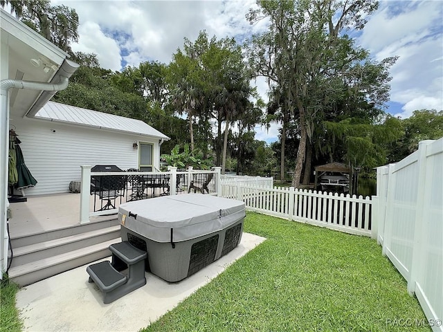 view of yard featuring a hot tub and a wooden deck