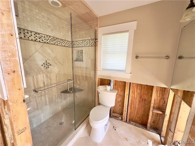 bathroom featuring tile patterned floors, toilet, and walk in shower