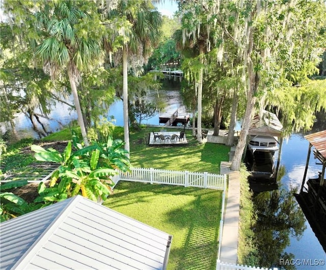 view of yard featuring a water view and a dock