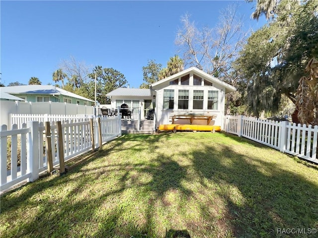 back of property with a wooden deck and a yard