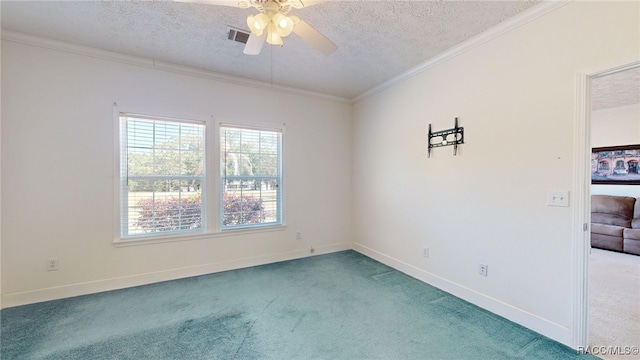 carpeted empty room featuring a textured ceiling, baseboards, visible vents, a ceiling fan, and ornamental molding