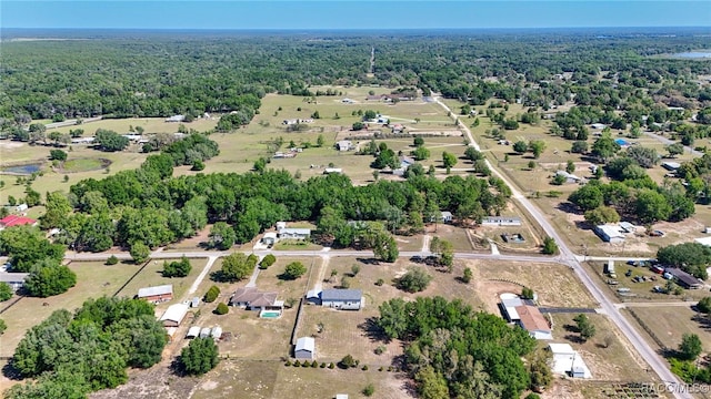 birds eye view of property featuring a wooded view