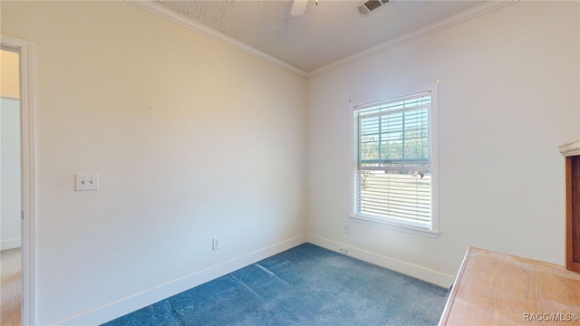 carpeted empty room with visible vents, crown molding, baseboards, a textured ceiling, and ceiling fan