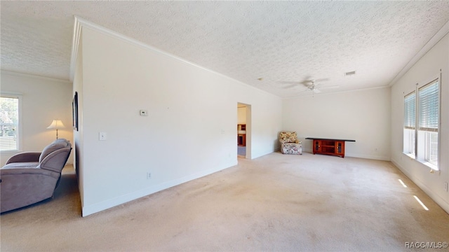 unfurnished living room with a wealth of natural light, a textured ceiling, and crown molding