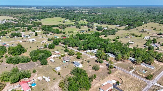 drone / aerial view featuring a view of trees