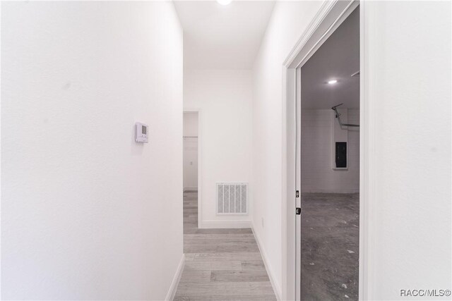 572 W Bluster Pl, Citrus Springs, FL 34434 - corridor featuring electric panel and light wood-type flooring