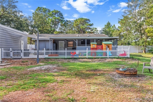 back of property with an outdoor fire pit and ceiling fan