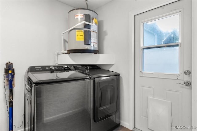 clothes washing area featuring electric water heater, plenty of natural light, and independent washer and dryer