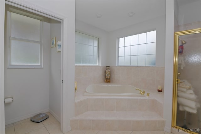 bathroom with tile patterned flooring and independent shower and bath