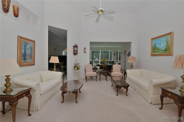 living room featuring light colored carpet, high vaulted ceiling, and ceiling fan