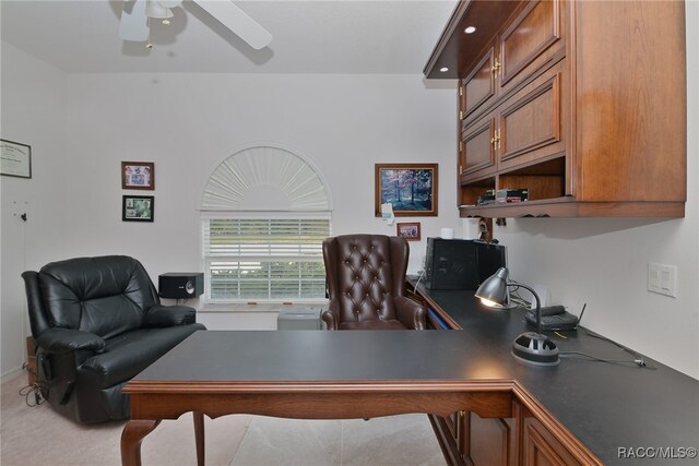 carpeted office space with ceiling fan