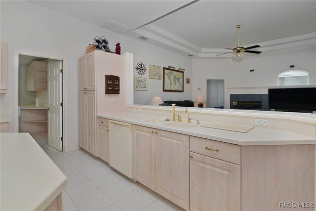 kitchen with light tile patterned floors, white dishwasher, ceiling fan, and sink