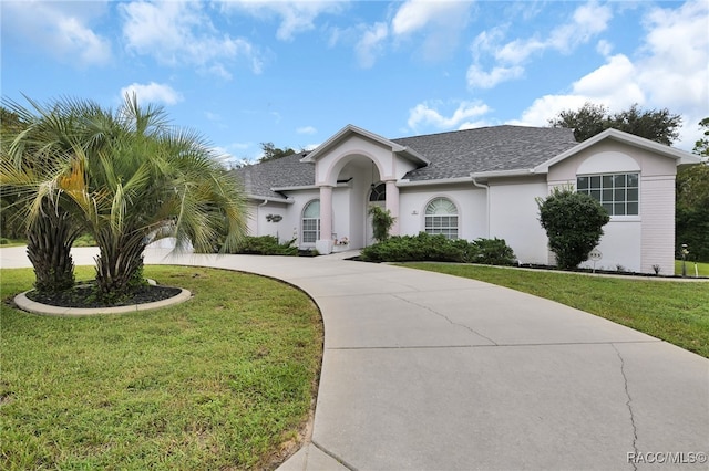 single story home featuring a front lawn