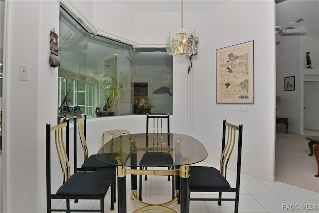 dining room with ceiling fan with notable chandelier and light colored carpet