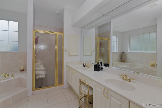 bathroom featuring tile patterned flooring, vanity, and shower with separate bathtub