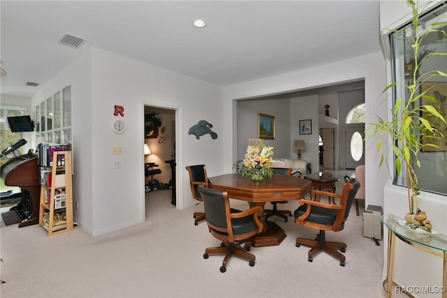 dining space featuring light colored carpet