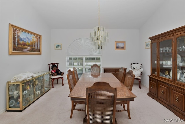 dining area featuring a chandelier, light carpet, and lofted ceiling