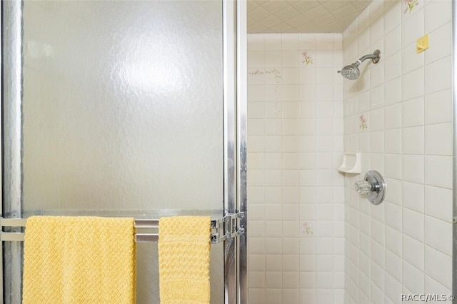 bathroom with a shower with door