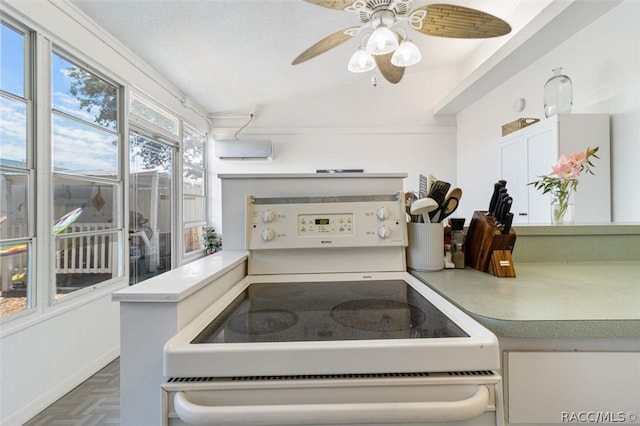 kitchen with white electric range, a wall unit AC, dark parquet floors, vaulted ceiling, and ceiling fan