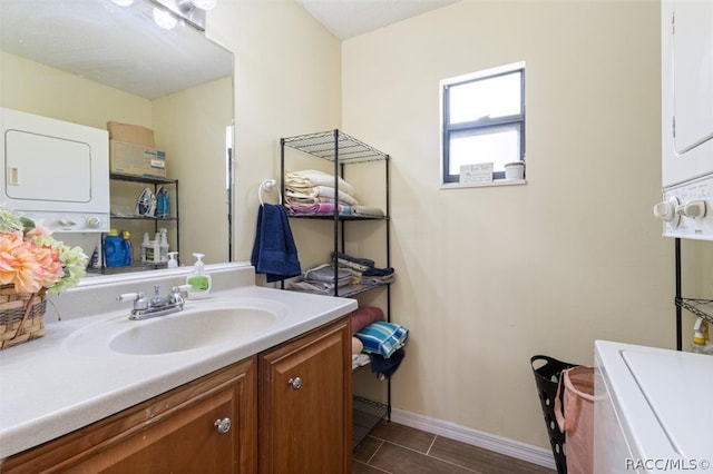 bathroom with vanity and stacked washer and dryer