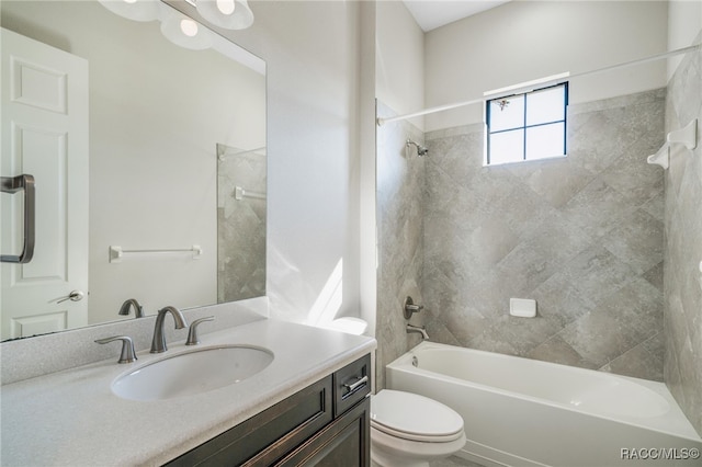 full bathroom with toilet, vanity, and tiled shower / bath