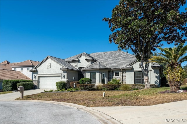 view of front of house with a front lawn and a garage