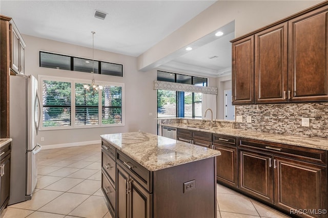 kitchen featuring a center island, stainless steel appliances, a notable chandelier, dark brown cabinets, and sink