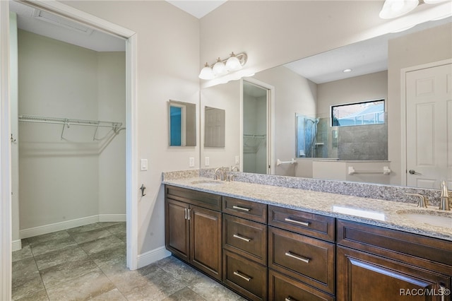 bathroom with tiled shower and vanity