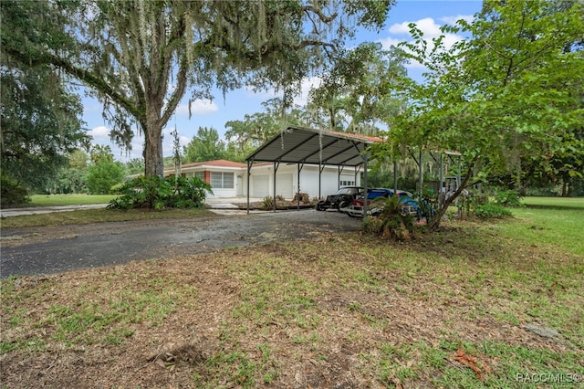 exterior space with a carport and a front yard