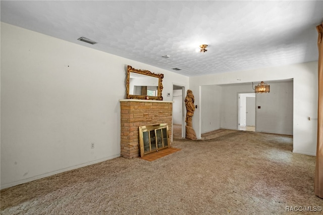 unfurnished living room featuring a stone fireplace and carpet floors