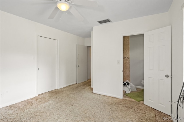 unfurnished bedroom featuring carpet floors, ensuite bathroom, and ceiling fan