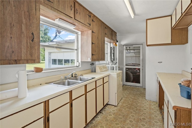 kitchen with washer and dryer and sink