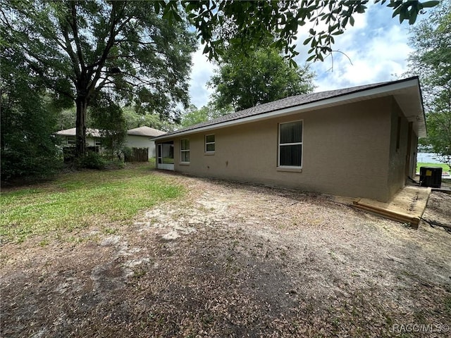 rear view of house with stucco siding