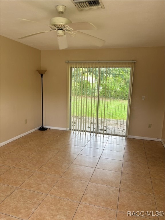 tiled empty room with ceiling fan