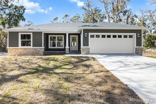 view of front of property featuring stone siding, concrete driveway, roof with shingles, and an attached garage