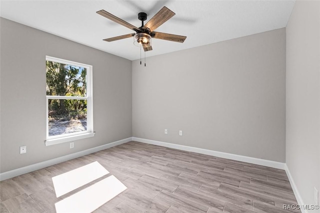 unfurnished room with light wood-style flooring, baseboards, and a ceiling fan