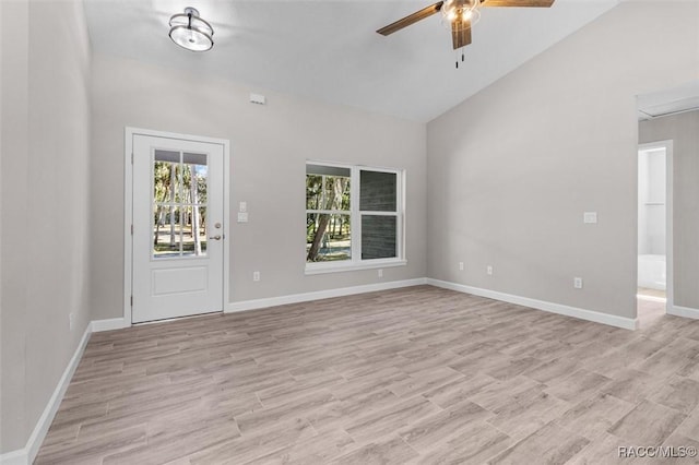 interior space with vaulted ceiling, baseboards, light wood-style flooring, and a ceiling fan