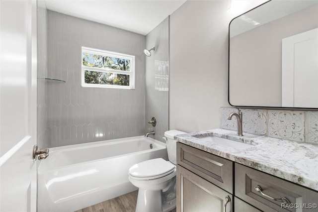 full bath with shower / bathing tub combination, vanity, toilet, and wood finished floors