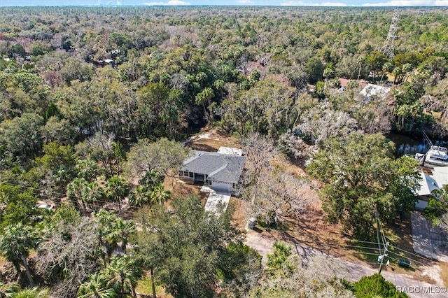 birds eye view of property with a forest view