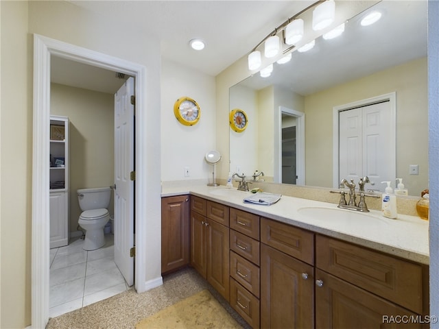 bathroom featuring tile patterned flooring, vanity, and toilet