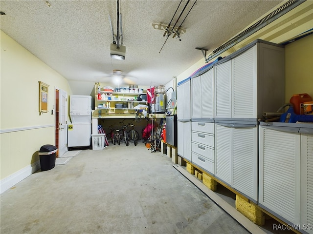 garage with stacked washer and dryer and a garage door opener