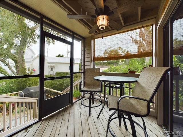 sunroom / solarium with ceiling fan