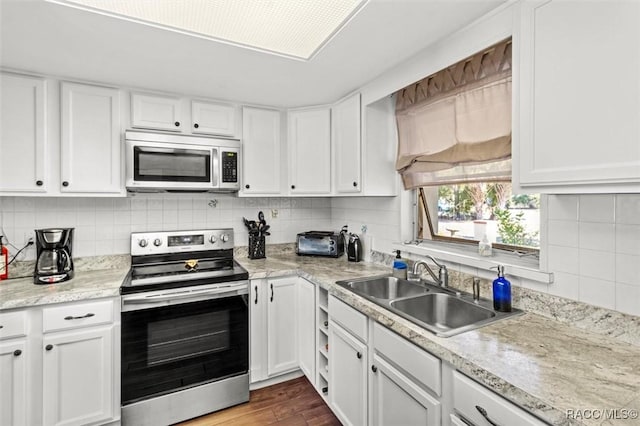 kitchen featuring white cabinetry, appliances with stainless steel finishes, and sink