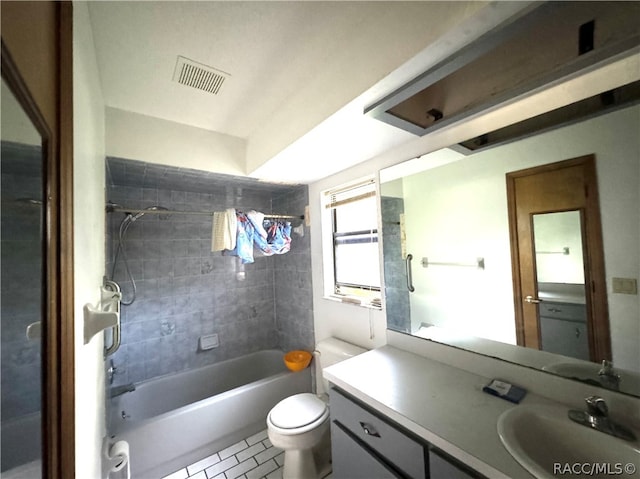 full bathroom with tile patterned floors, toilet, vanity, and tiled shower / bath