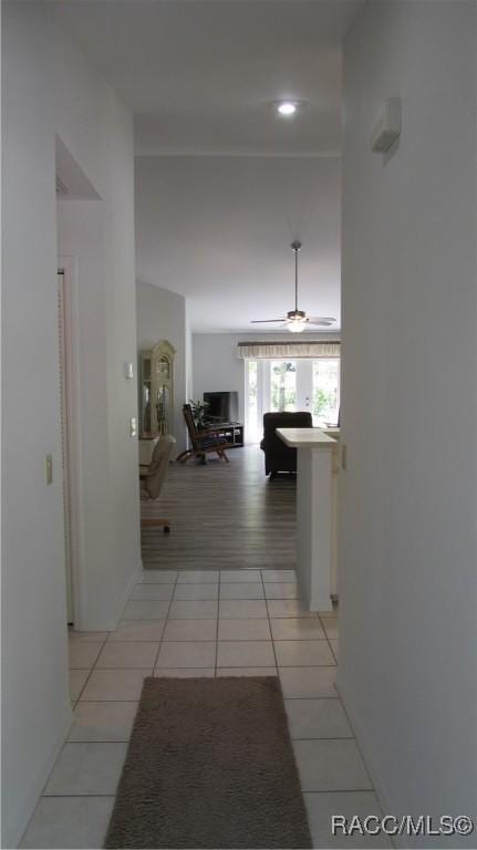 hall with recessed lighting and light tile patterned floors