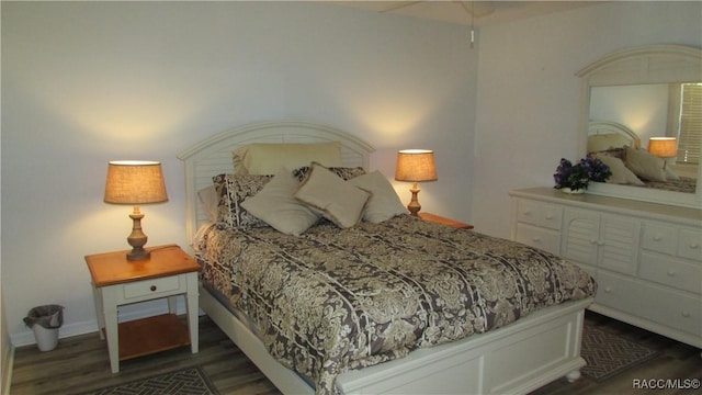 bedroom featuring baseboards and wood finished floors